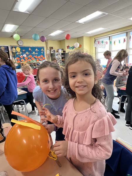 Students smiling with animal balloons