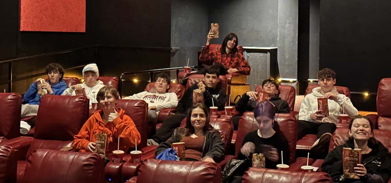 students in movie theatre posing for picture