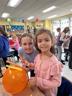 Students smiling with animal balloons