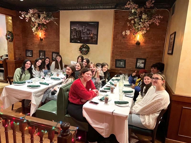 Students smiling for picture in restaurant