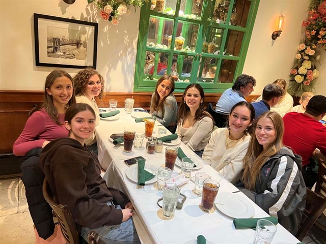 Students smiling for picture in restaurant