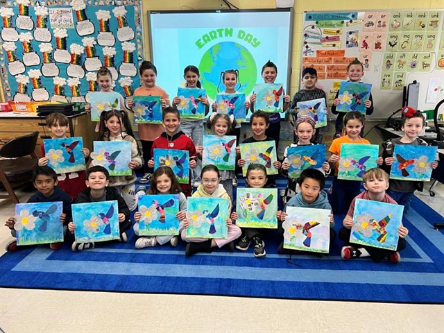 Students posing with their art projects