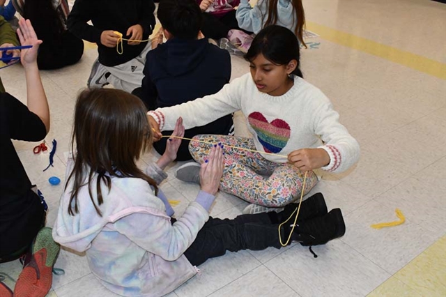 students playing with yarn