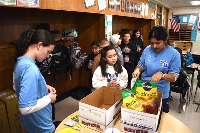 High School students helping elementary students