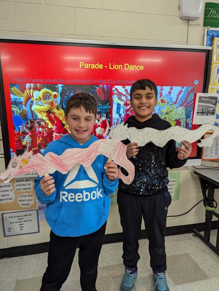 Students holding paper dragon