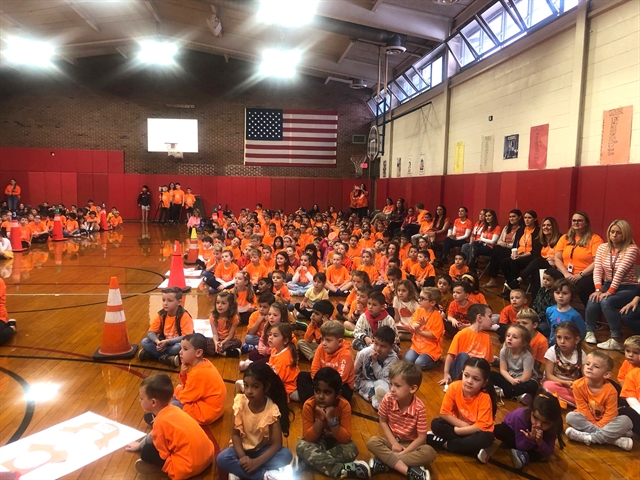 Students wearing orange at assembly