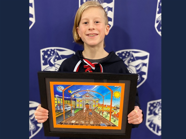 picture of student holding artwork