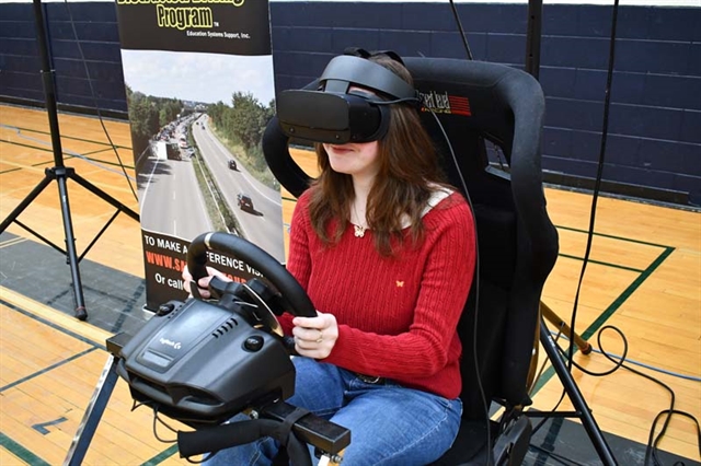 student in virtual reality driving simulator