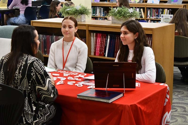 students at desk networking