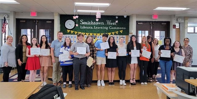 students holding awards