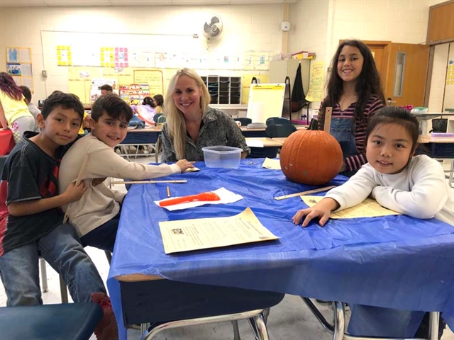 Students and parents with pumpkins