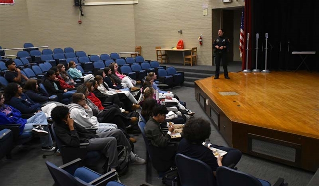 Officer speaking to students
