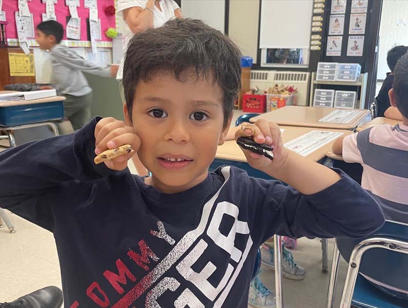 student holding up cookies