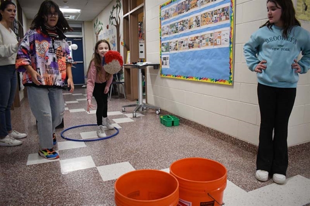 Kids tossing bean bags