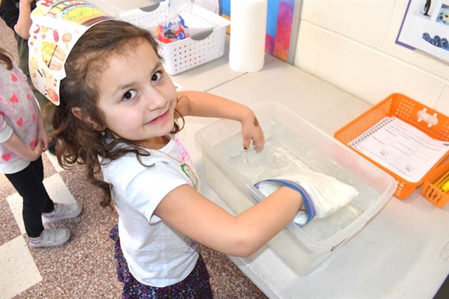 Student putting hands in cold water