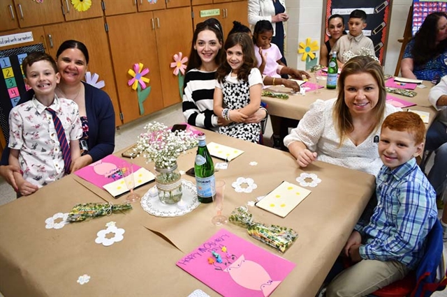 Mothers and children at a classroom table