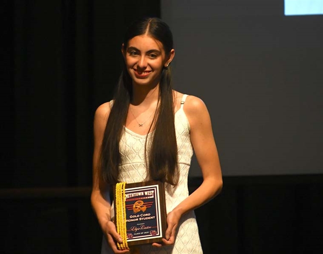 Student on stage receiving award