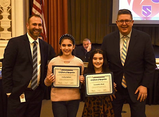 Superintendent and kids posing for picture