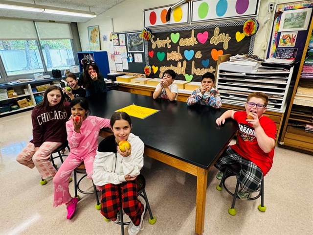 students in class with apples