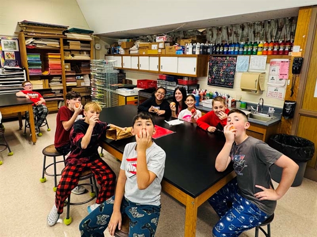 students in class with apples