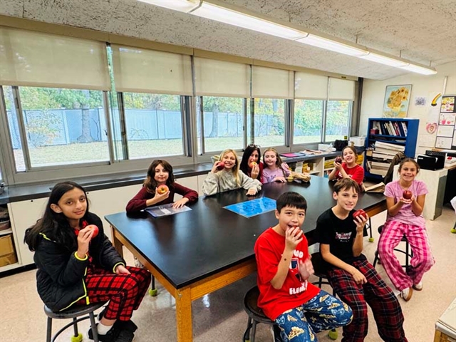 students in class with apples