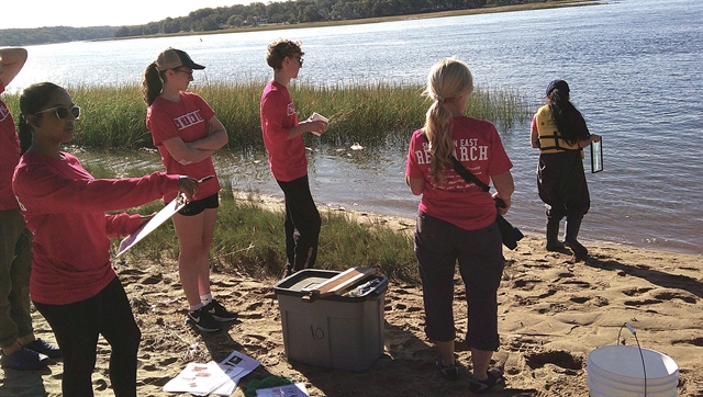students and Ms. Zeitlin on beach