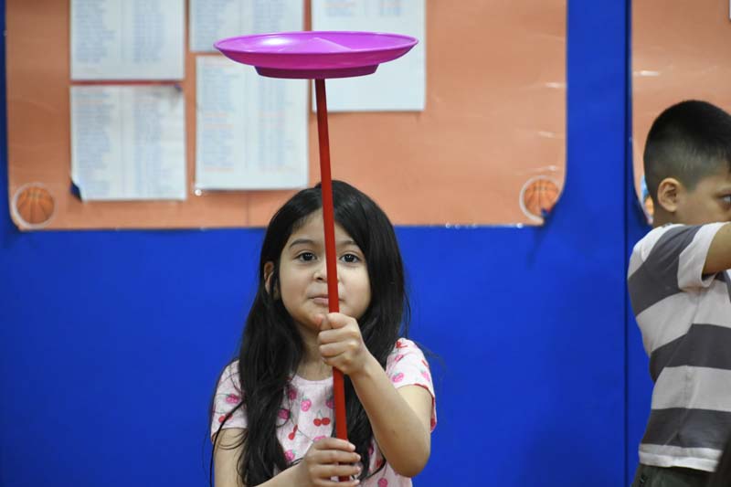 Student doing circus tricks