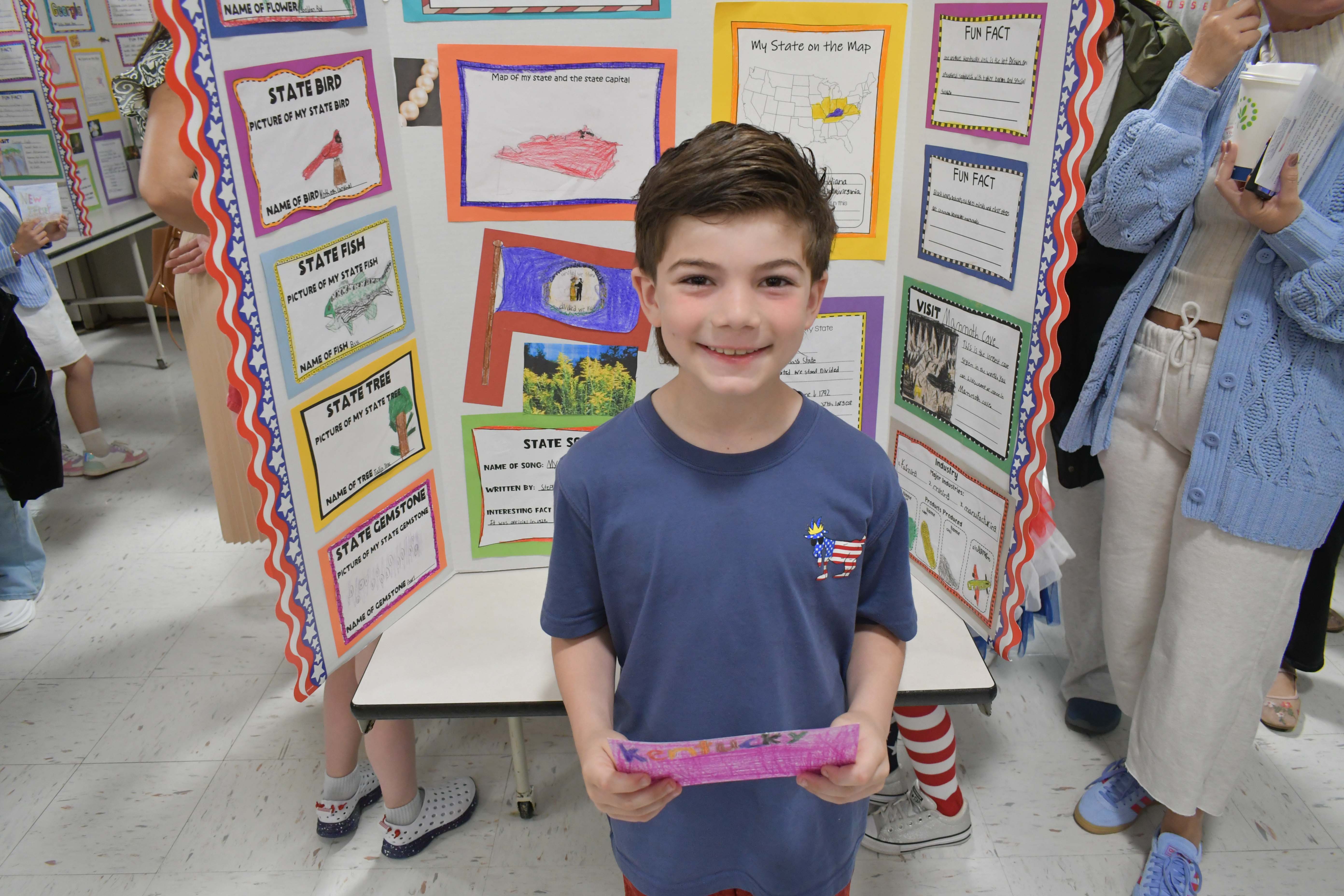 Student in front of sign project