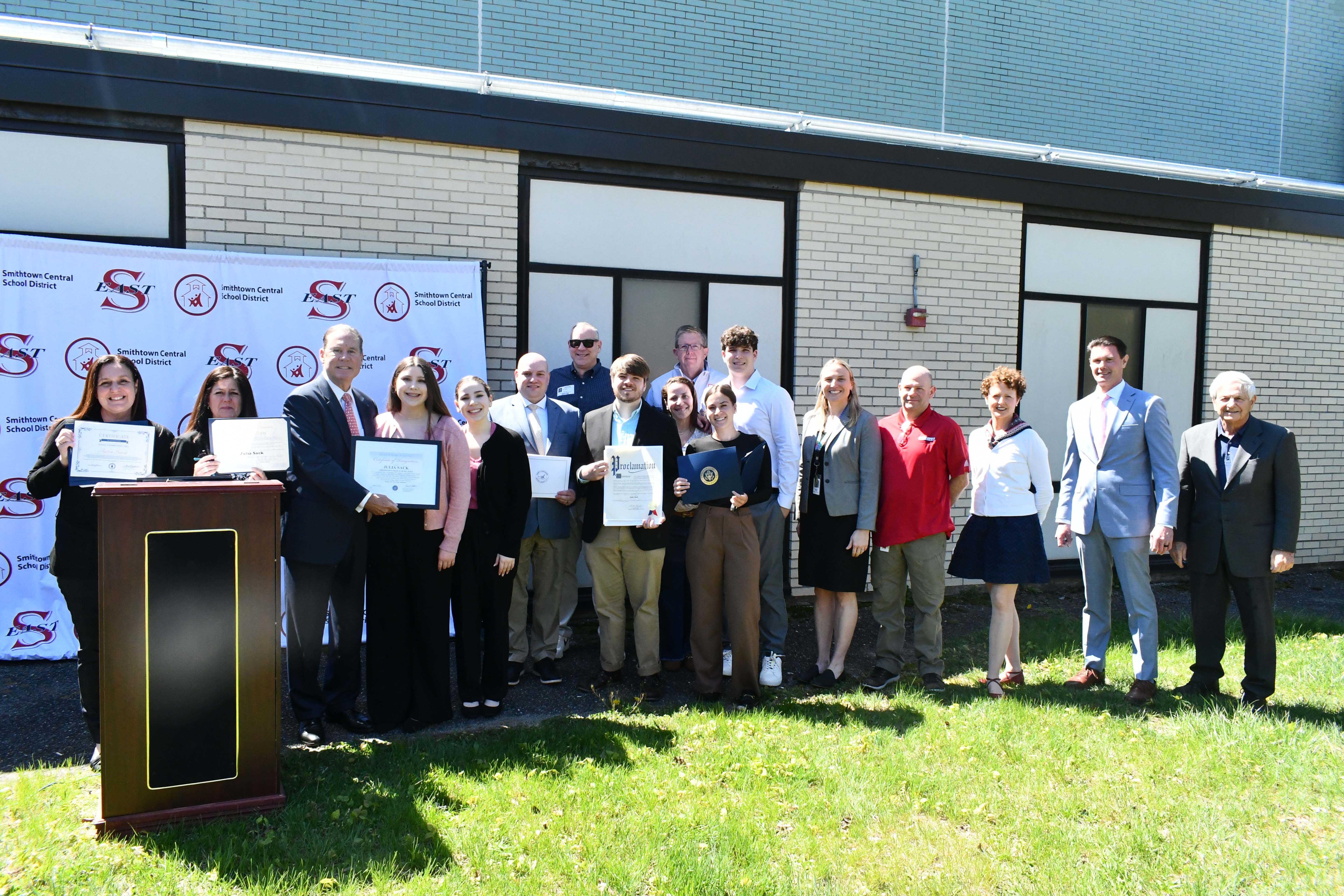 group picture behind podium