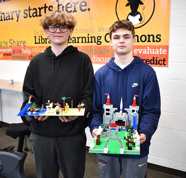 Students posing with lego fixtures