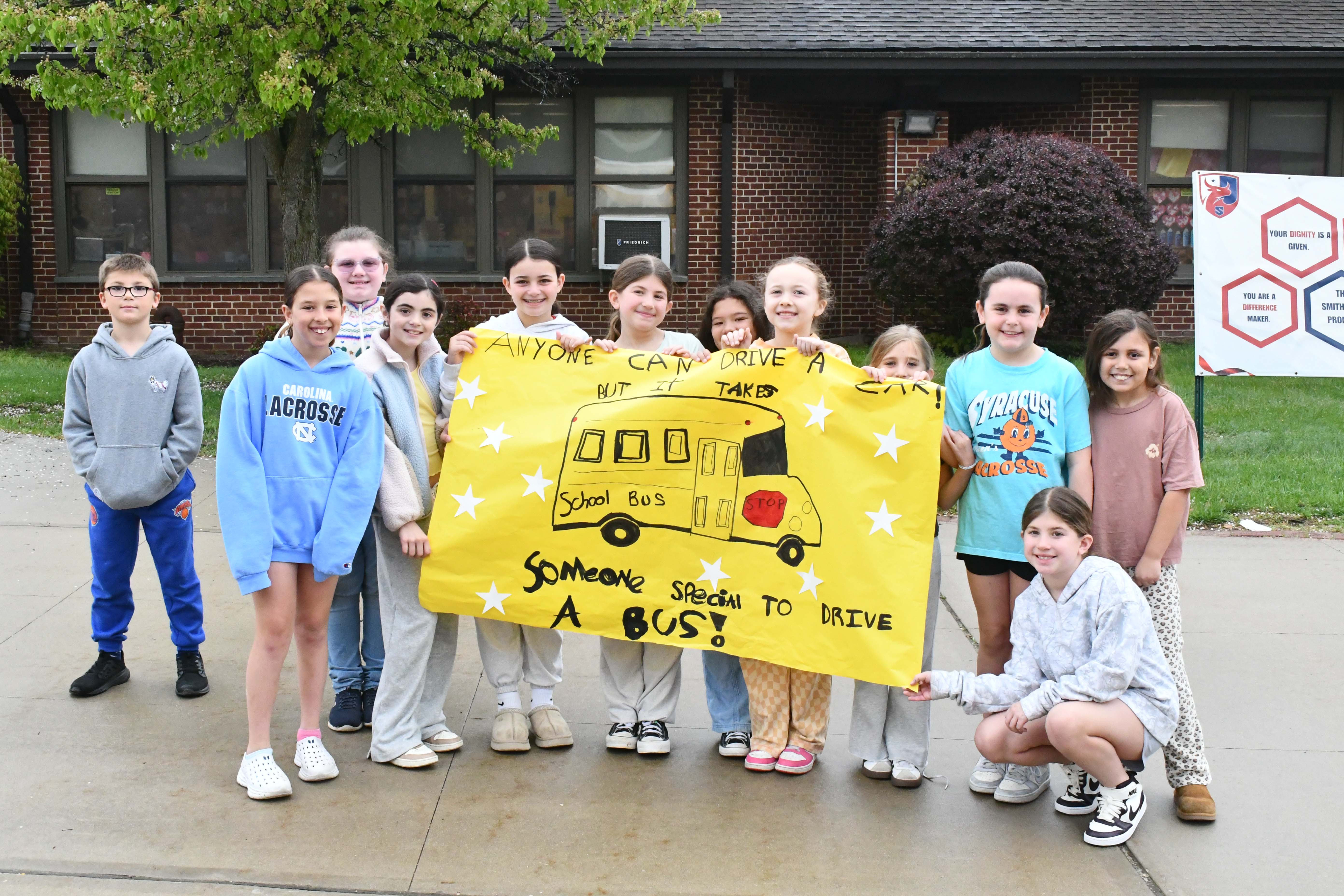 students holding bus appreciation sign