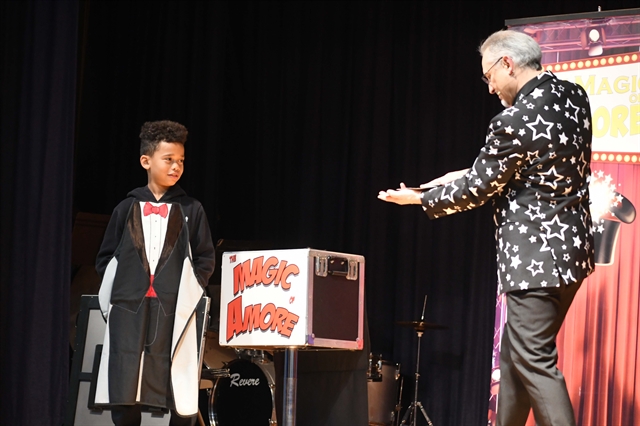 Magician and student on stage