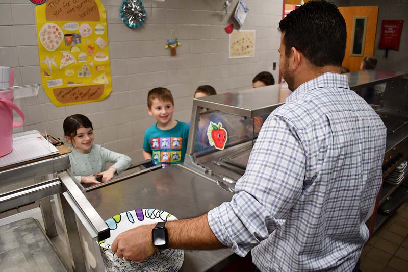 Principal Ierano serving pancakes