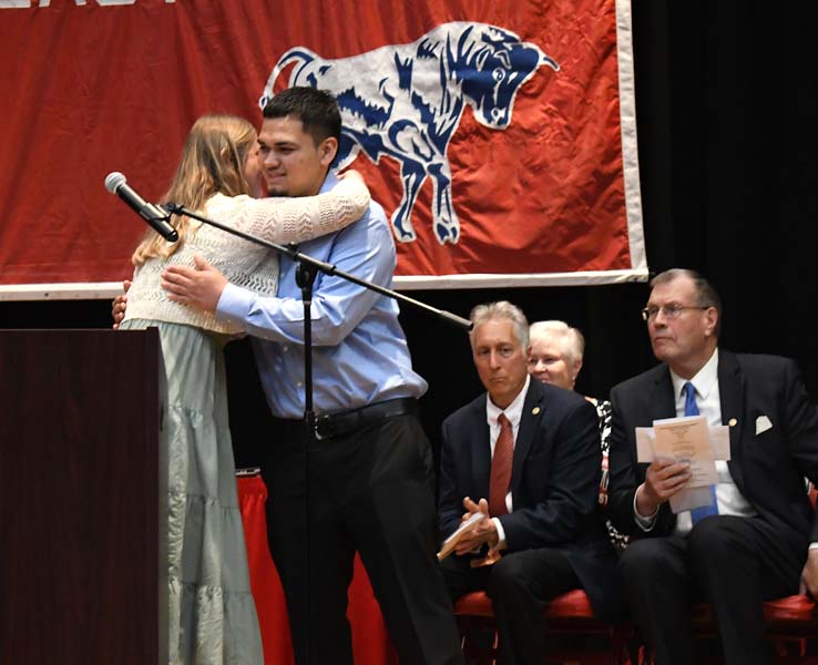 Counselor hugging student