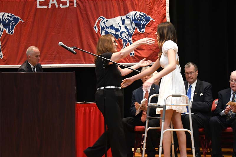 Counselor hugging student