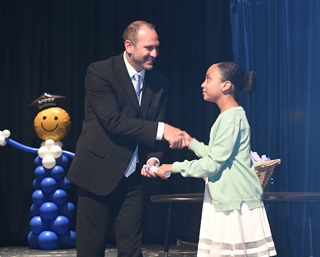 Principal Hellmuth handing out certificate