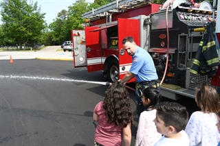 Firefighter using fire hose