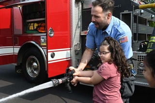 Student using fire hose