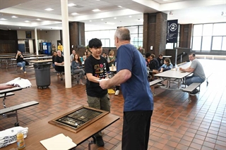 student shaking hands