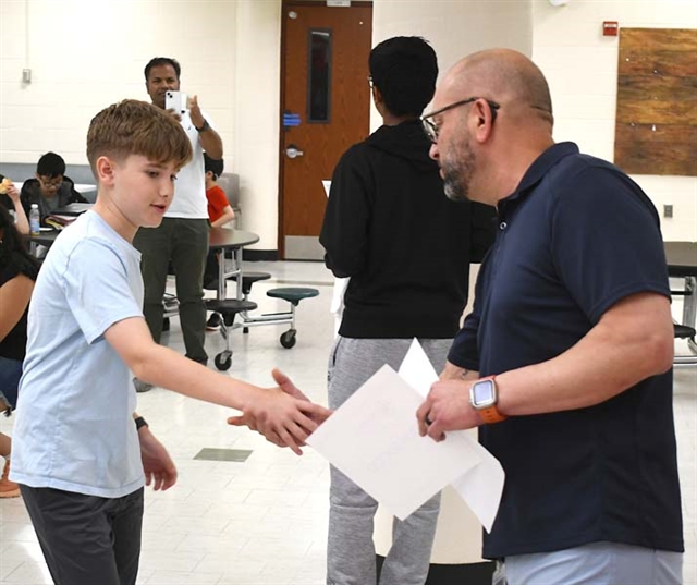 student shaking hands