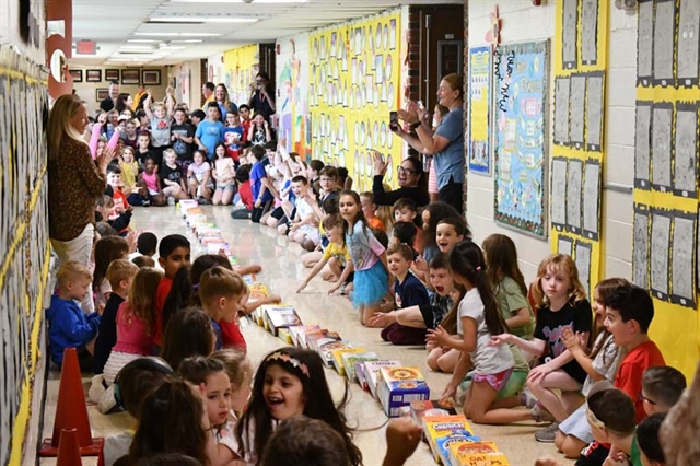 Students in hallway with cereal boxes