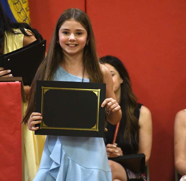 student smiling holding certificate