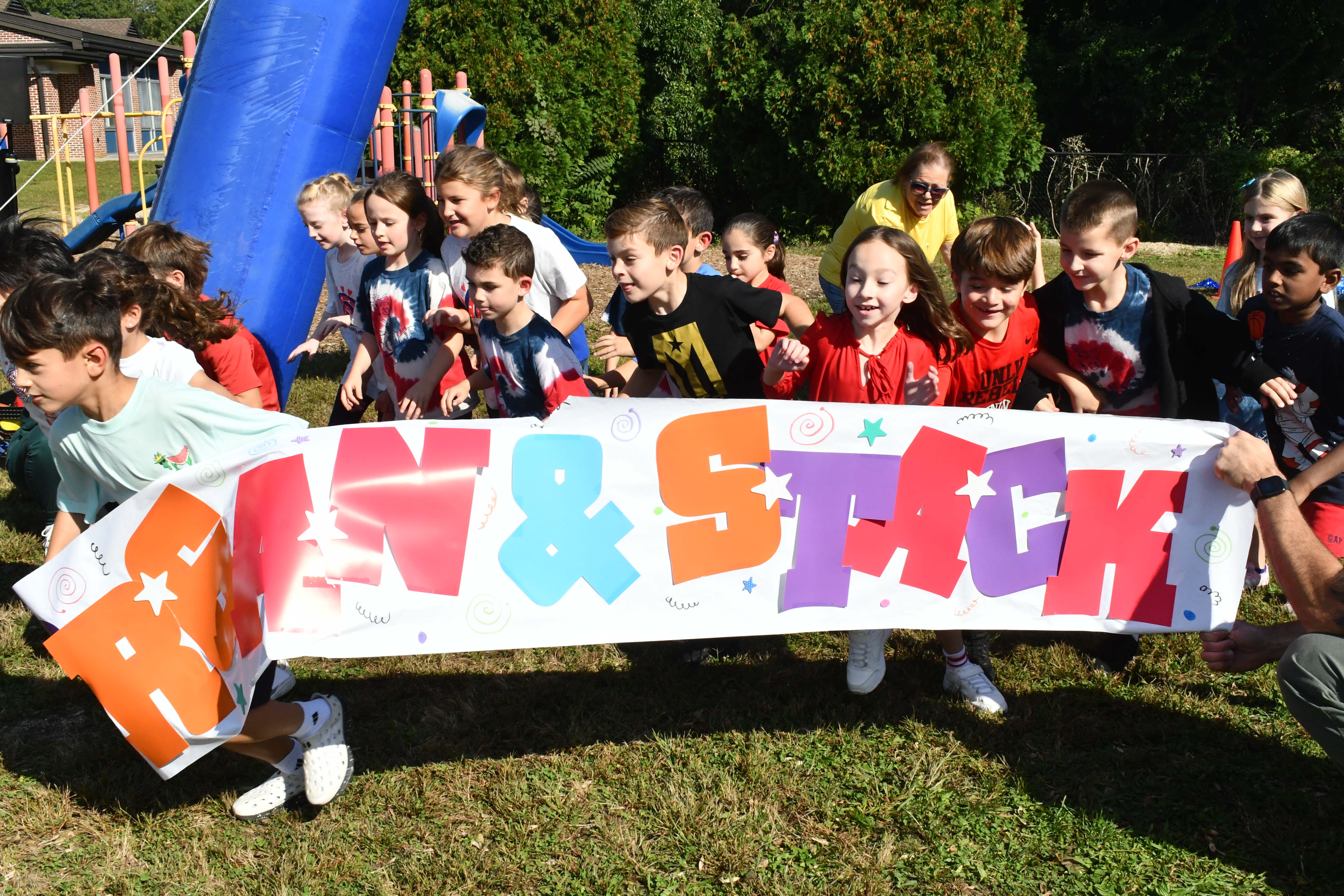 students by a banner
