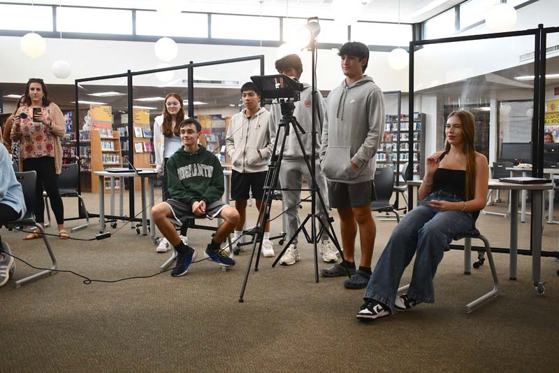 Students interviewing a subject