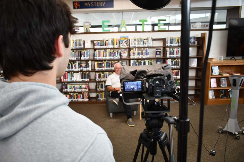 Students interviewing a subject