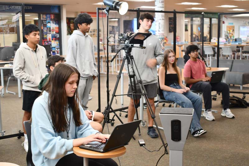 Students interviewing a subject