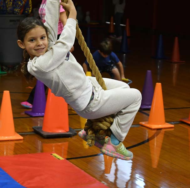 Student on swinging rope
