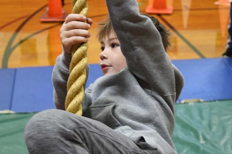 Student on swinging rope