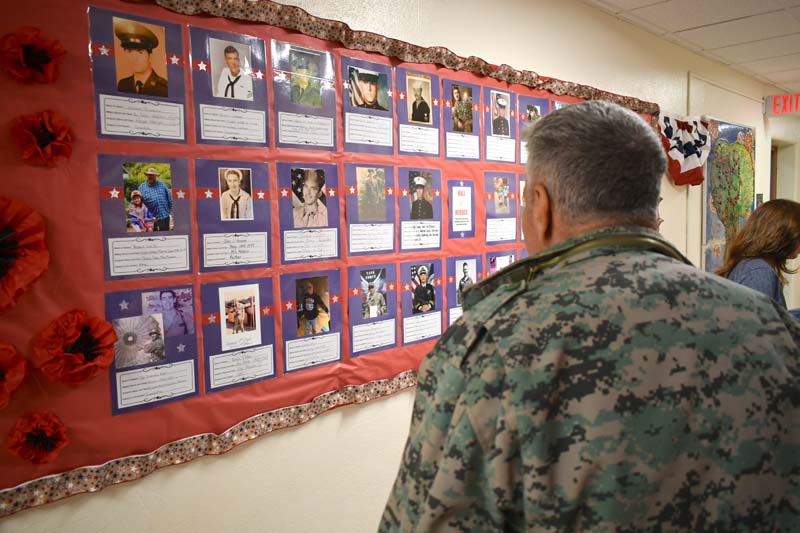 veteran looking at a wall of heroes