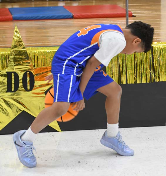 boy dribbling a basketball